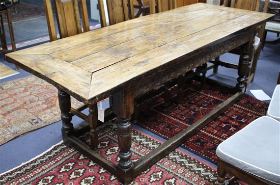 An oak refectory style dining table with cleated four-plank top L.210cm